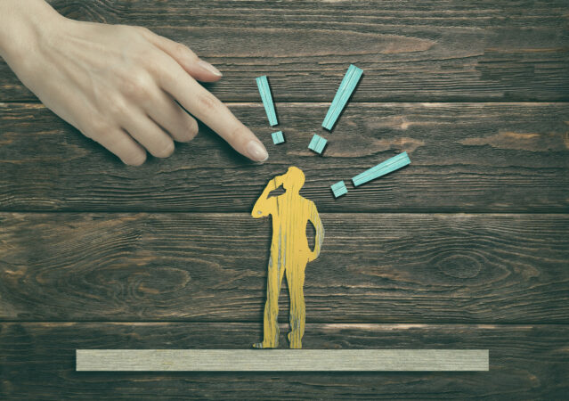 finger pointing at man with exclamation points over his head