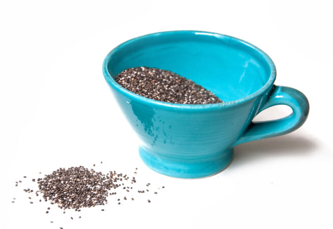 aqua mug of chia seeds plus more on white background